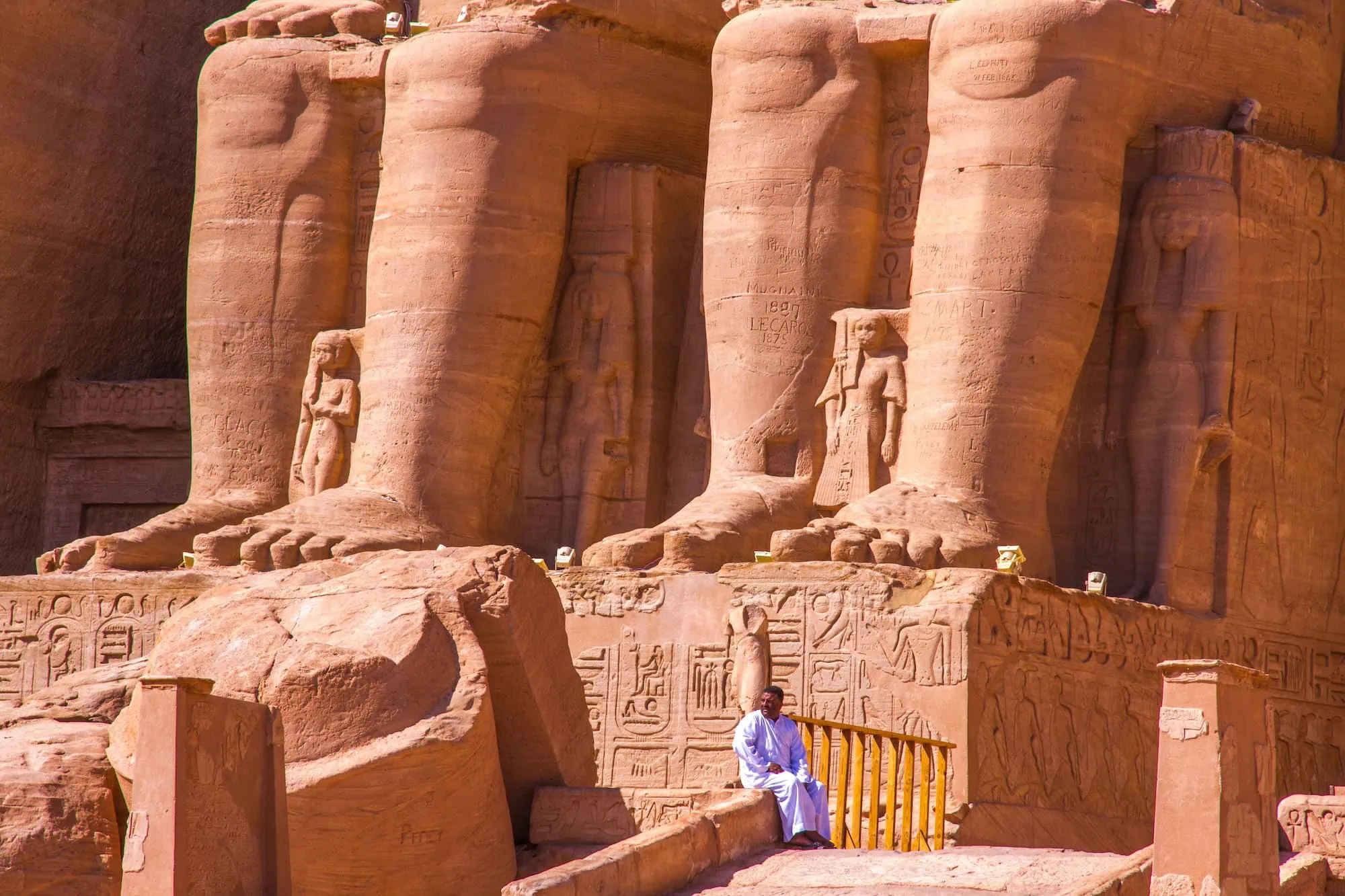 Colossal statues of Pharaoh Ramesses II carved into the Abu Simbel temple facade in Egypt