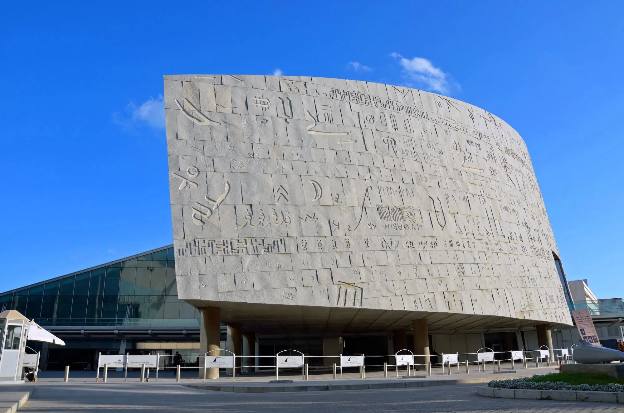Modern Bibliotheca Alexandrina building facade with hieroglyphic inscriptions and glass elements
