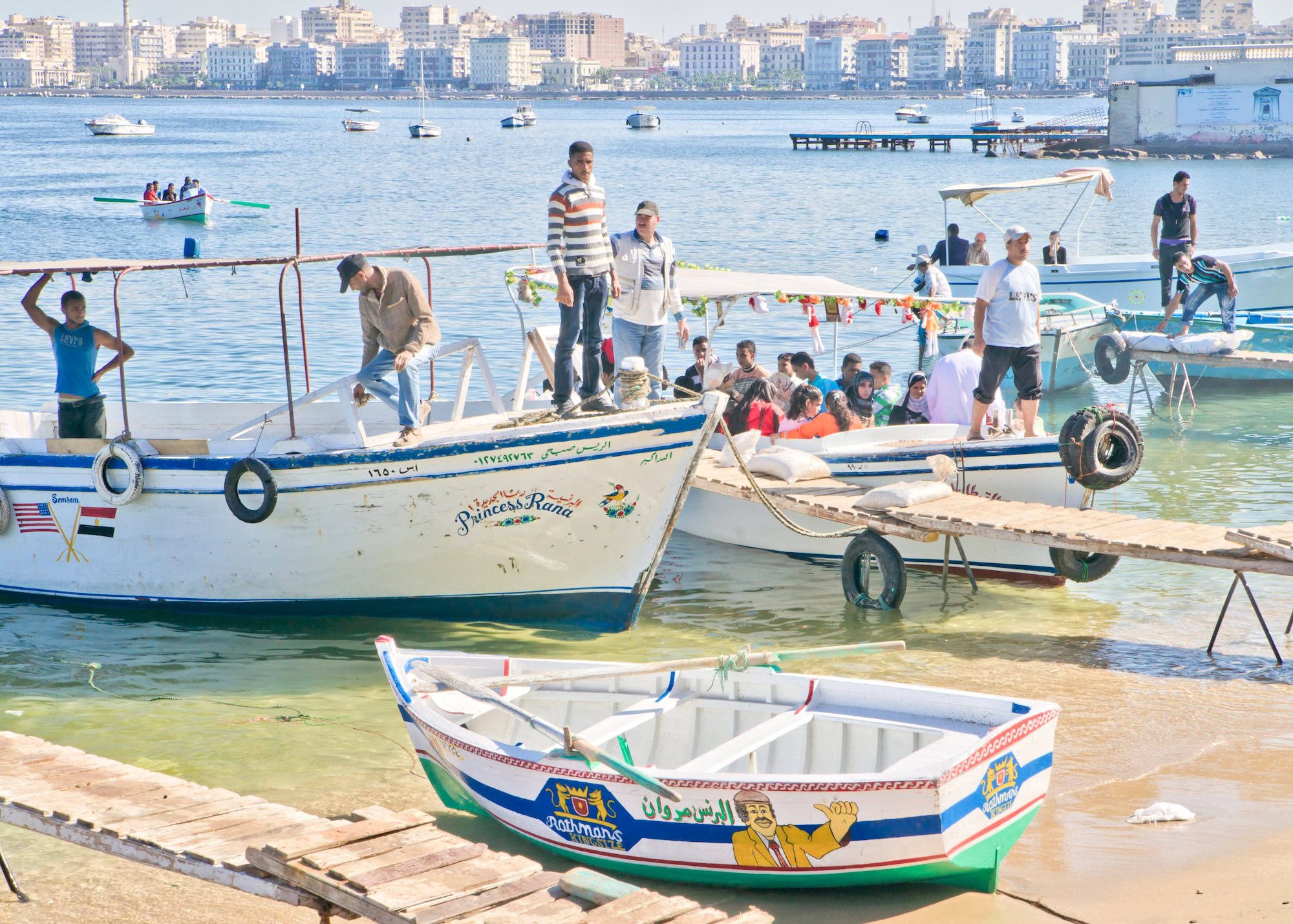 Alexandria harbor with fishing boats and people shopping at the waterfront market