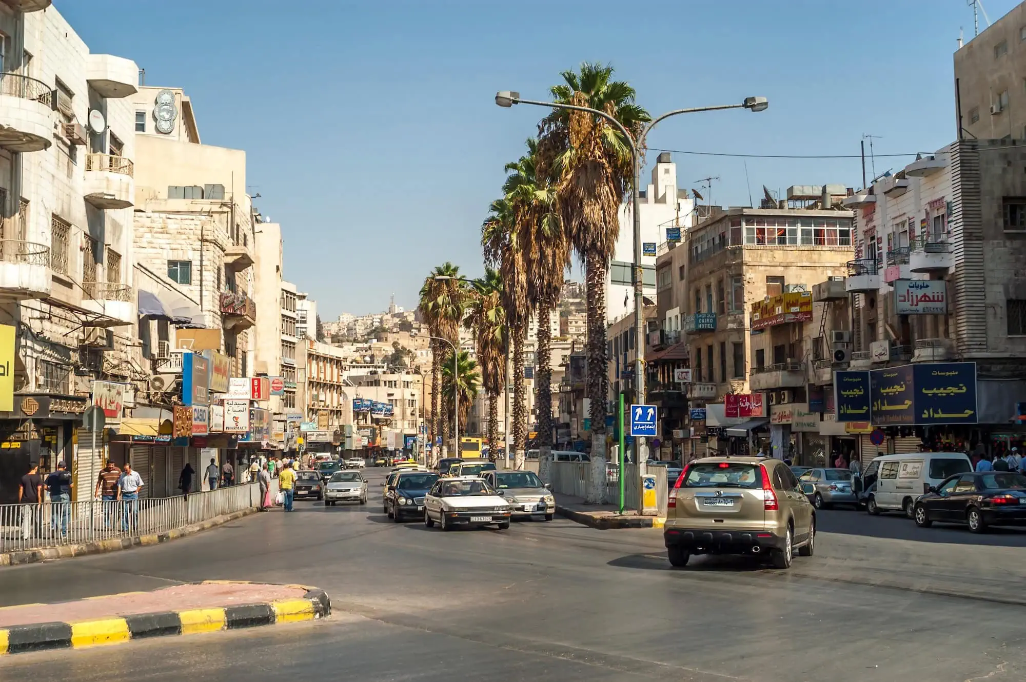 Busy street scene in Amman with traffic and commercial buildings