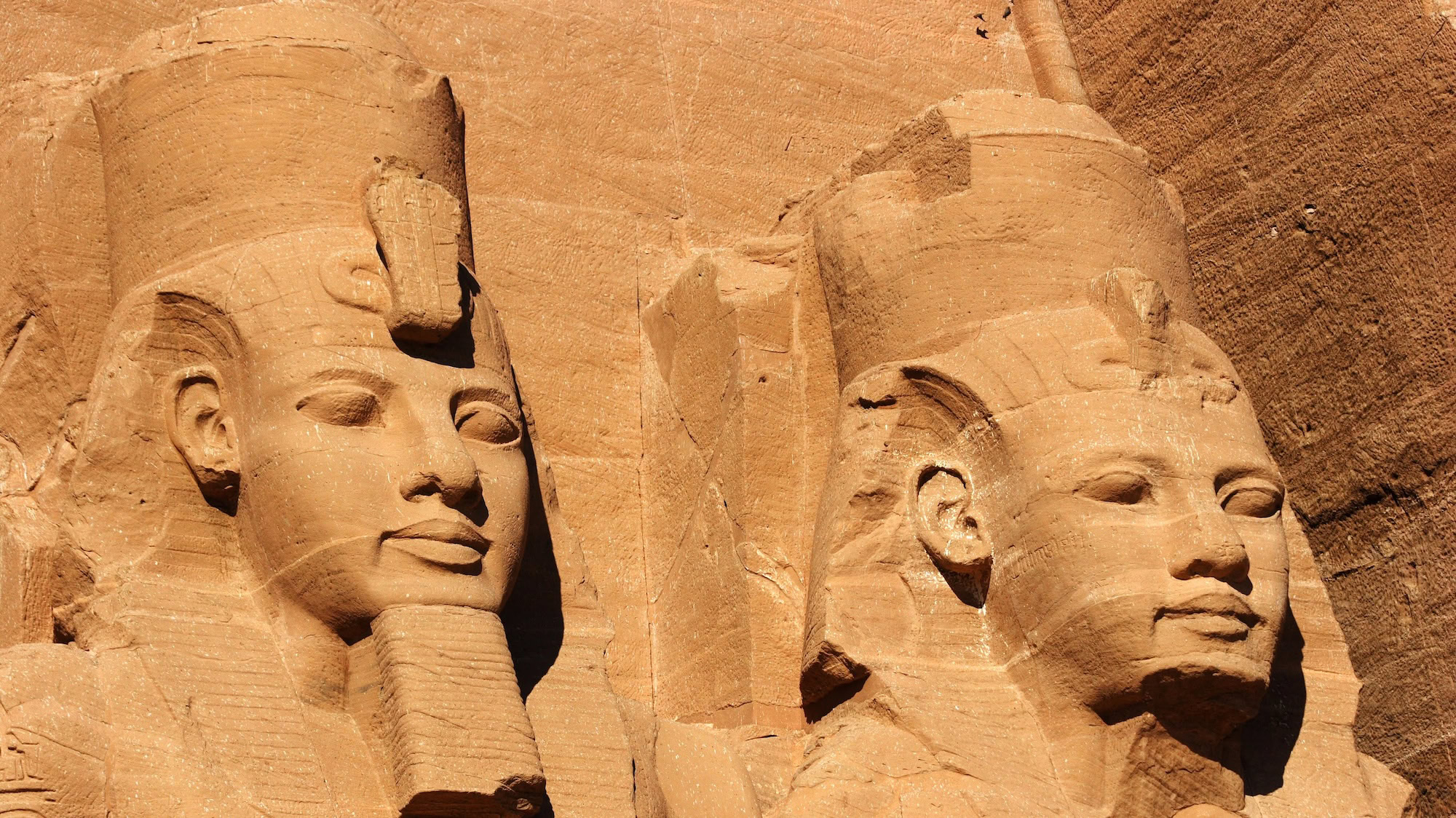 Colossal pharaoh statues carved in sandstone at Abu Simbel temple