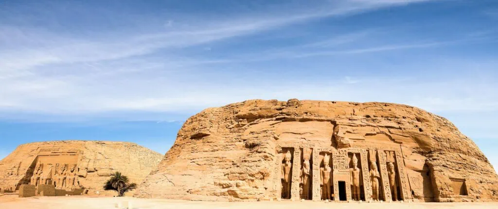 The Small Temple of Abu Simbel on Lake Nasser, Egypt — facade with six standing rock-cut statues, four of Ramses II and two of Queen Nefertari, all at equal height