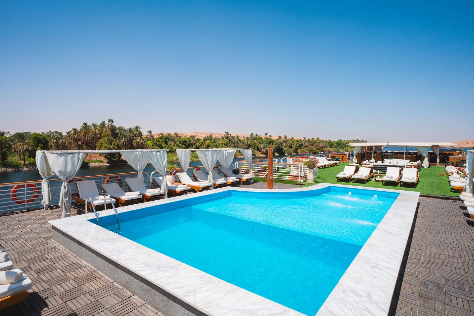 Luxurious Nile River cruise ship deck with swimming pool and lounge chairs