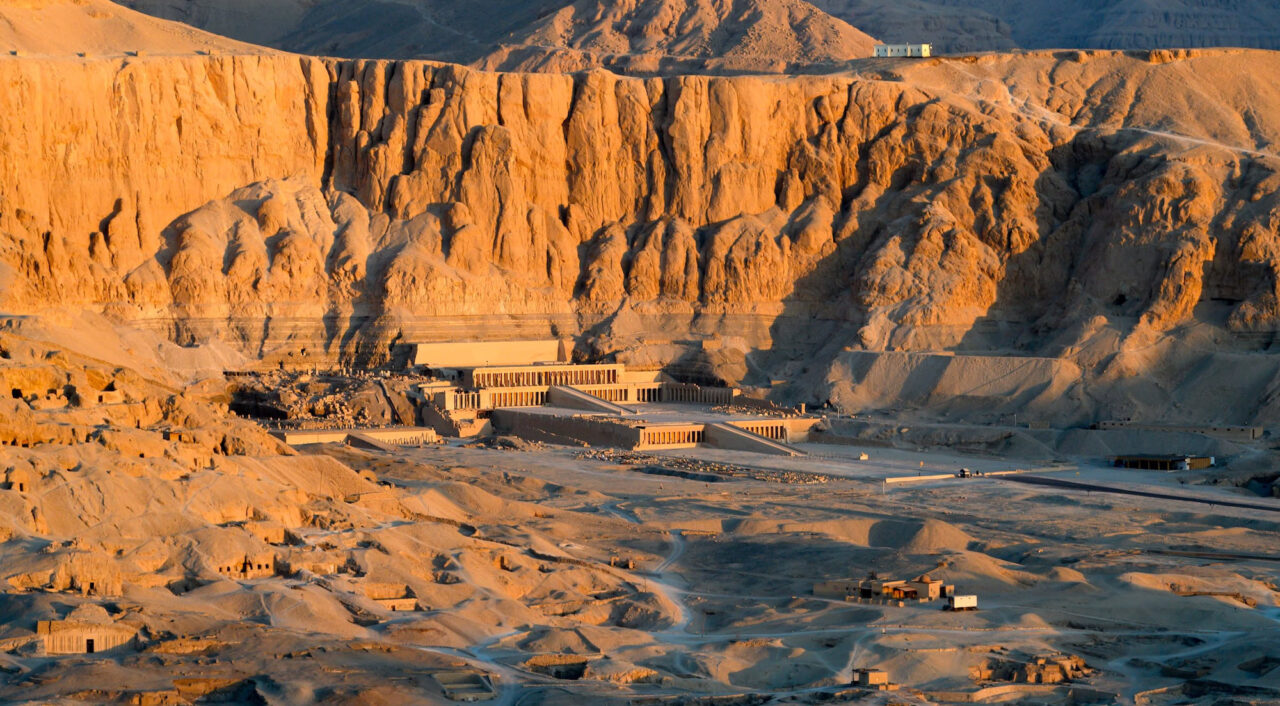 Aerial view of Hatshepsut Temple at sunrise in Luxor, Egypt – a highlight of Egypt tours from NYC, nestled beneath red cliffs on the Nile’s west bank in the Valley of the Kings.