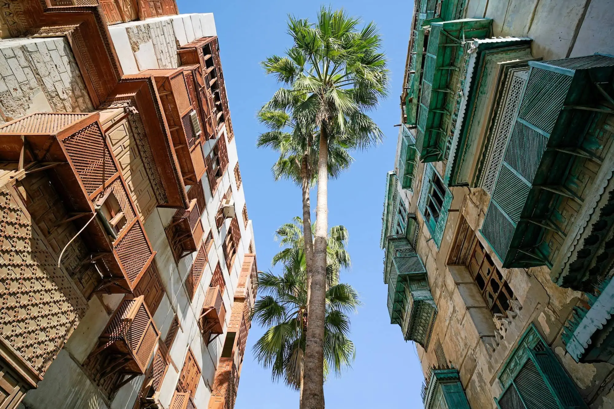 Traditional coral-stone buildings with carved wooden mashrabiya balconies in Al-Balad, the historic UNESCO-listed district of Jeddah, Saudi Arabia