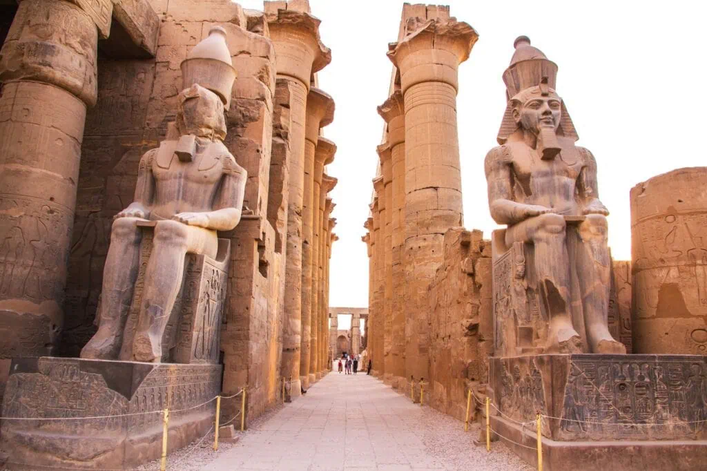 Seated statues of Ramesses II lining the colonnade inside Luxor Temple, Luxor