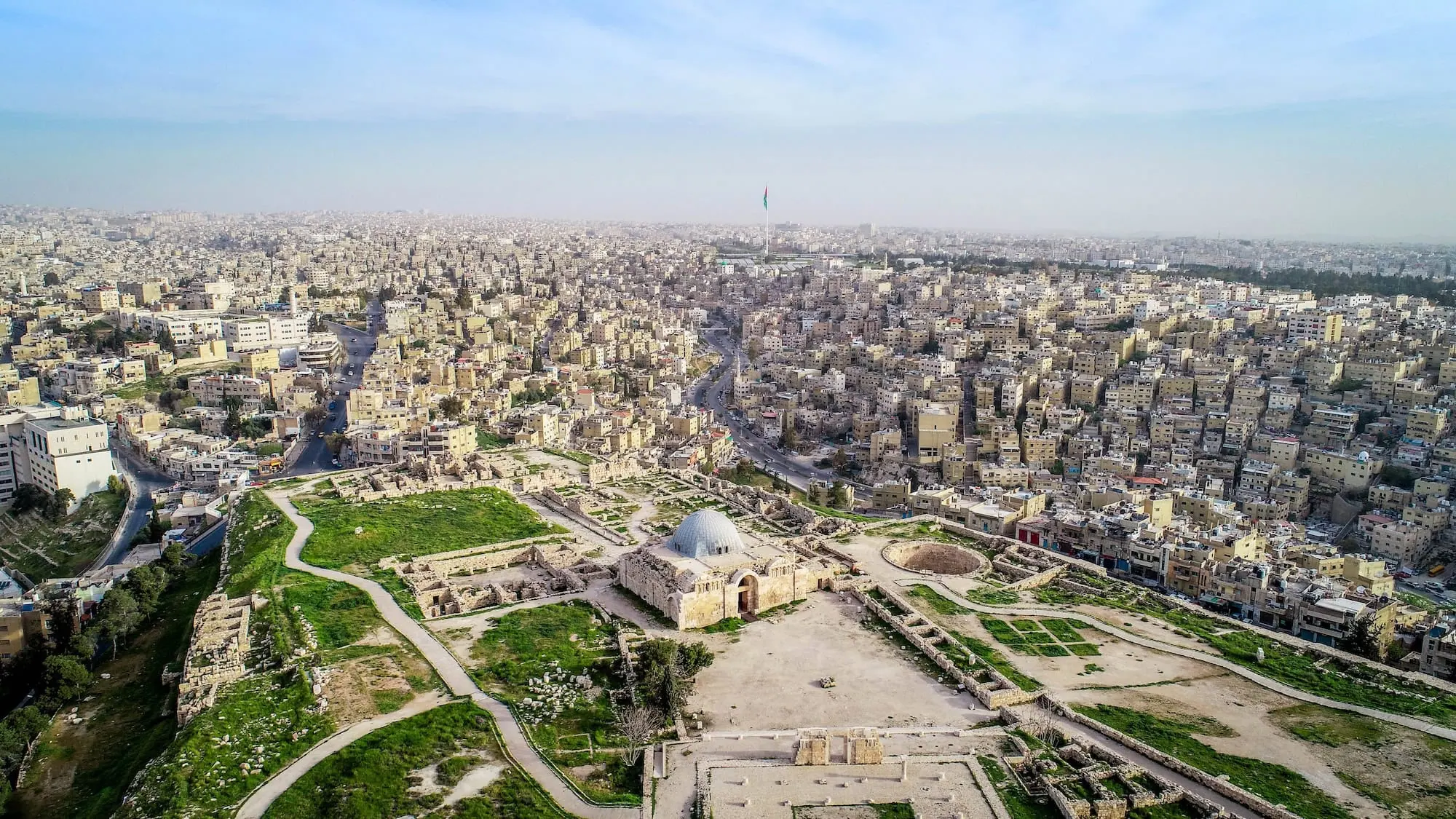 Aerial view of Amman Citadel archaeological site with ancient ruins and modern cityscape