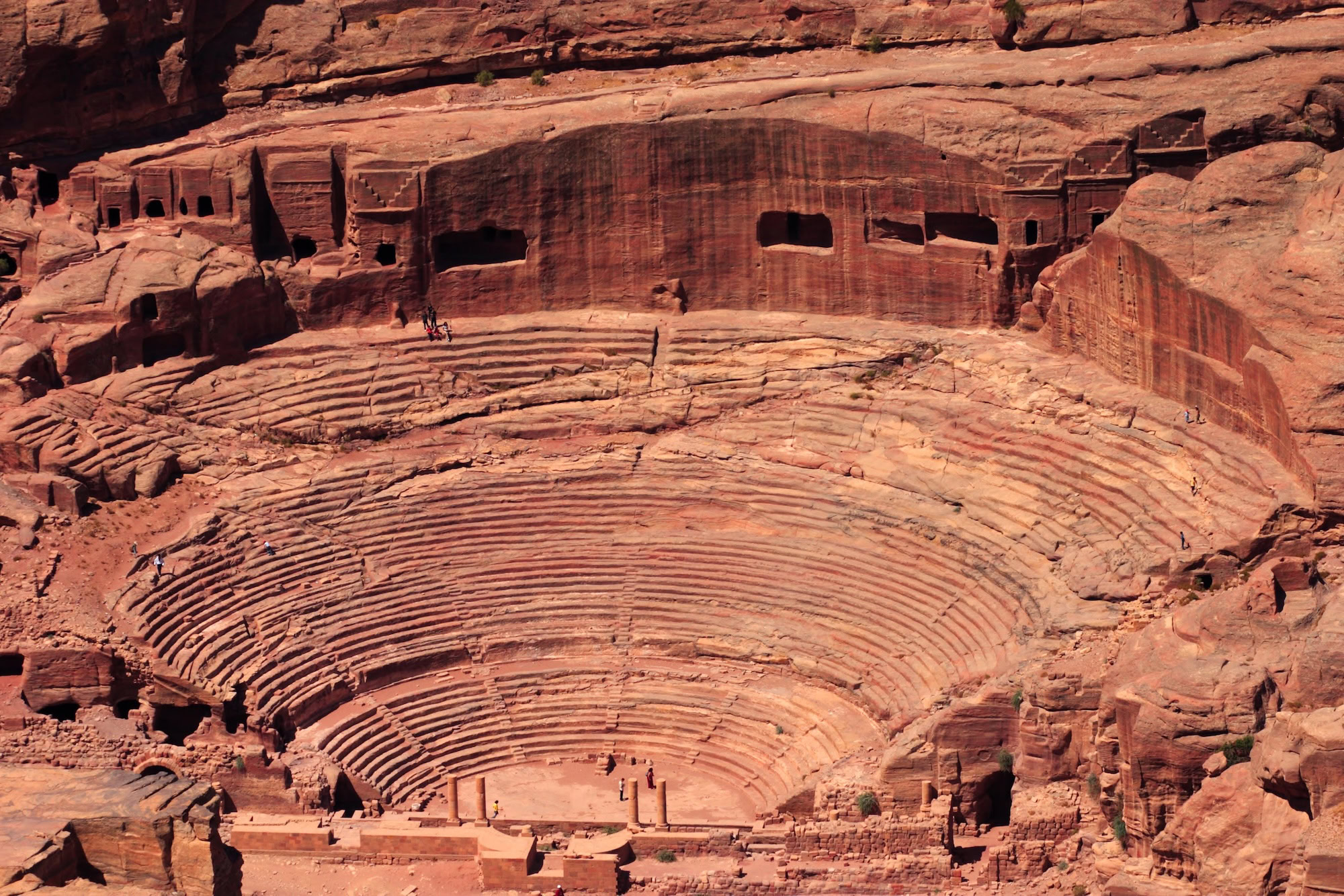 Ancient Roman amphitheater carved into sandstone cliffs at Petra, Jordan