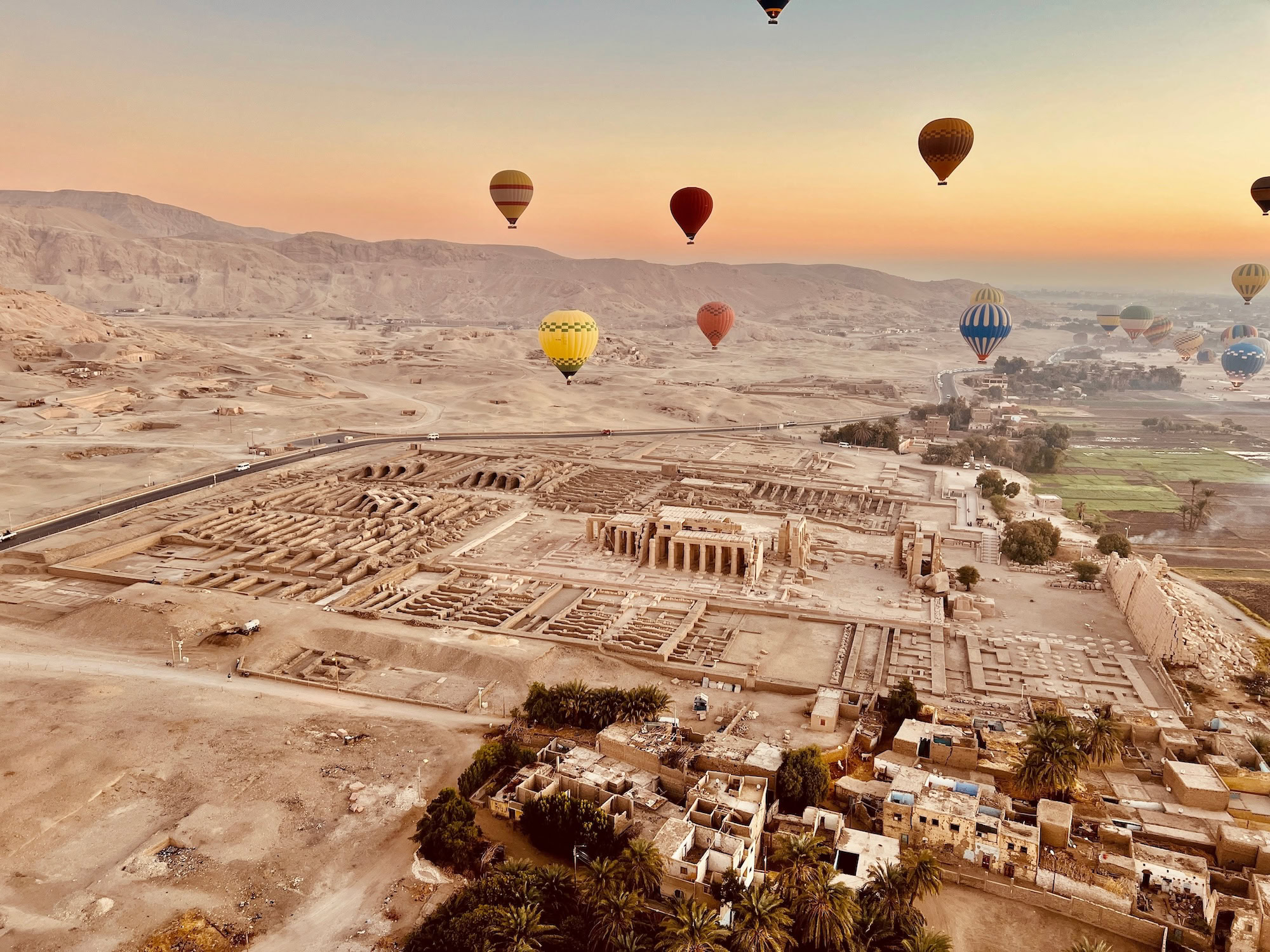 Aerial view of Medinet Habu Temple ruins in Luxor with hot air balloons