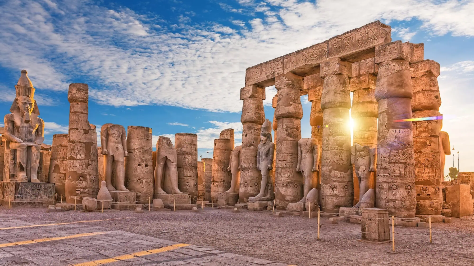 Majestic Luxor Temple complex with ancient columns, pharaoh statues, sphinxes and hieroglyphic carvings