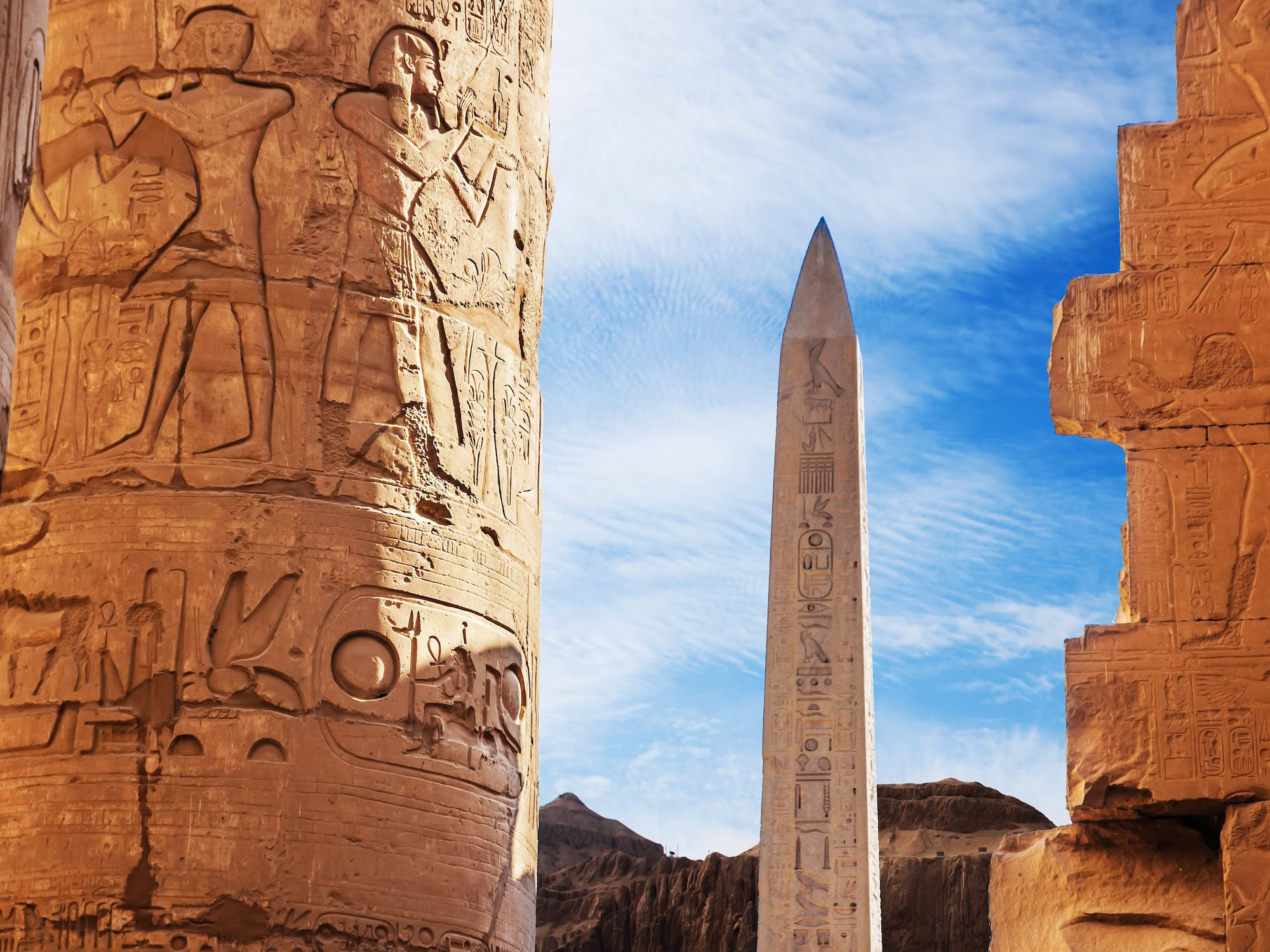 Ancient obelisk and hieroglyphic columns at Karnak Temple Complex in Luxor, Egypt
