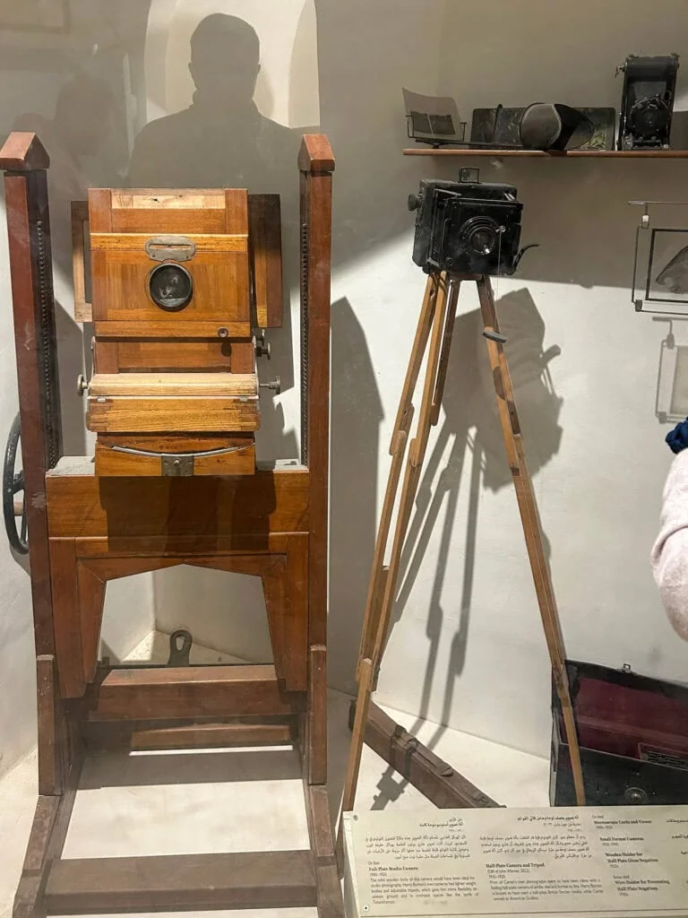 Antique wooden and metal field and plate cameras with tripods displayed inside the Howard Carter House museum, Luxor