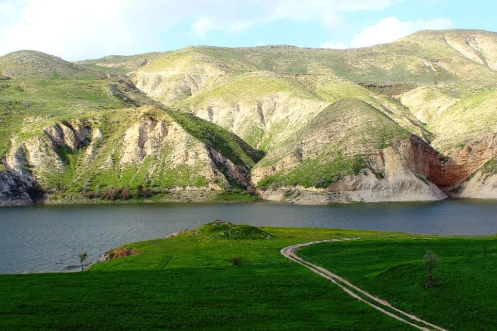 Arab Valley Dam with reservoir water bordered by hills and surrounding landscape, Irbid
