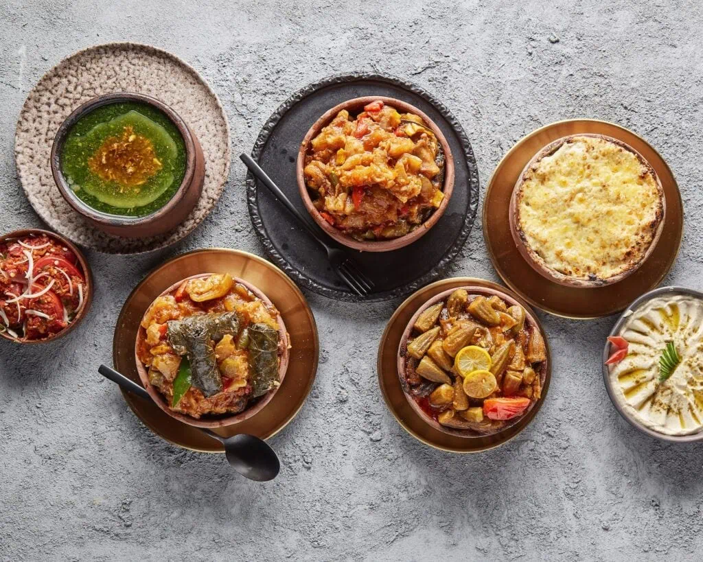 Middle Eastern and North African feast with tagine, fattah, kabab, kabsa, and kofta, traditional dishes shared across Egyptian and Moroccan cuisine.
