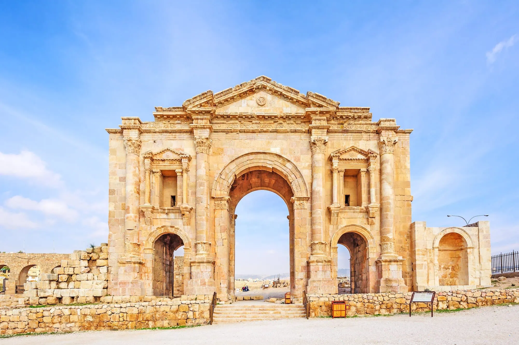 Ancient Roman Hadrian's Arch at Jerash with three arched openings and ornate columns