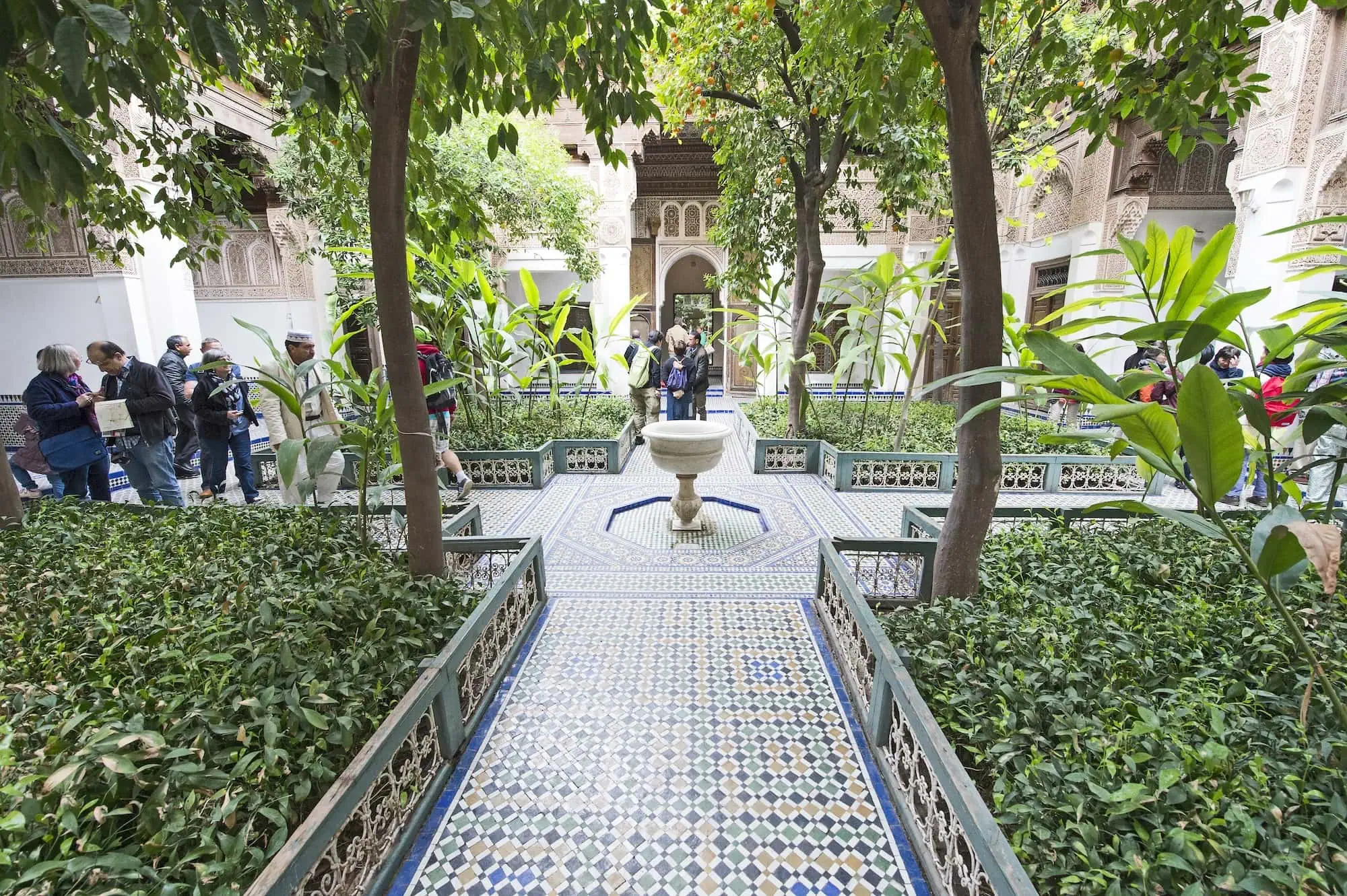 Beautiful courtyard of Bahia Palace in Marrakech with ornate fountain and lush gardens