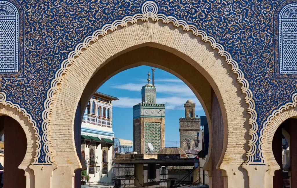 Bab Bou Jeloud ornate blue-tiled gate with arches and surrounding medina entrance, Fes