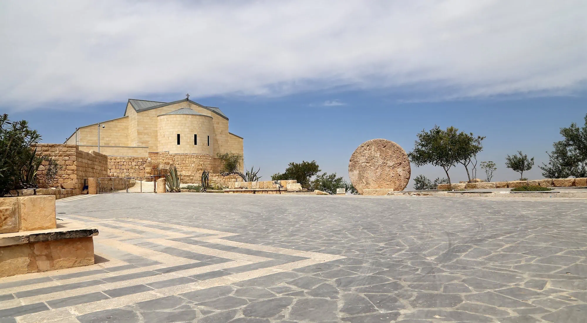 Modern stone basilica with ancient ruins at Mount Nebo Memorial Church
