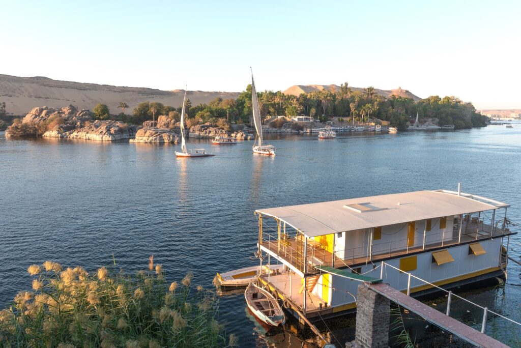 Beautiful scenic view of an Egyptian house boat on the River Nile from Elephantine Island Aswan Egypt