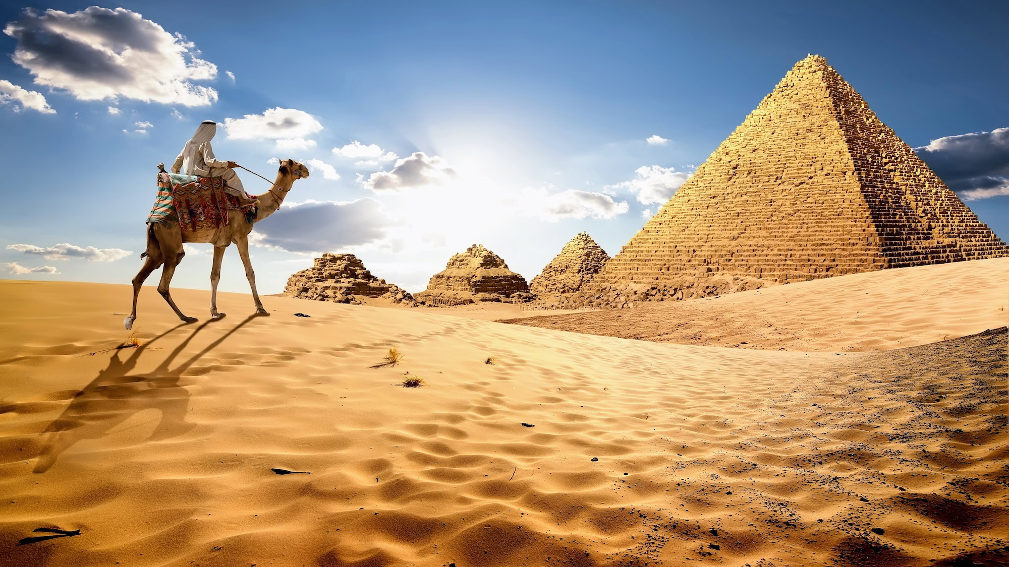 Camel rider at the Pyramids of Giza in Egypt's desert landscape
