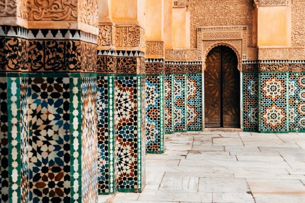 Ben Youssef Mosque courtyard with prayer hall façade and minaret structure Marrakech