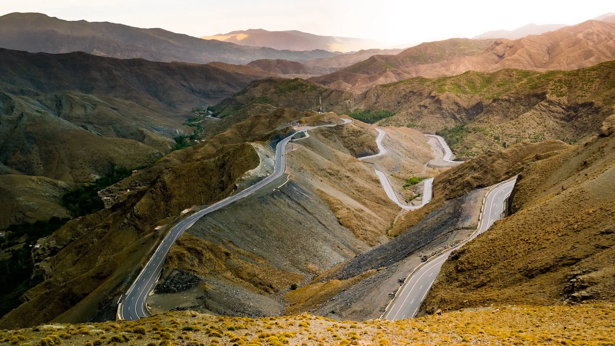 Serpentine road winding through High Atlas Mountains showing mountainous terrain