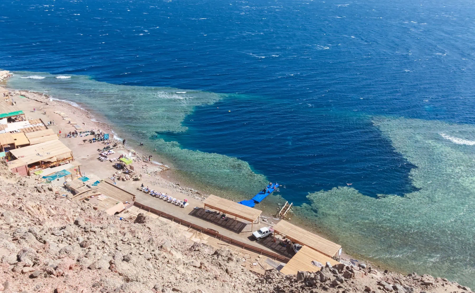 Aerial view of the Blue Hole diving site in Dahab, Egypt showing the deep blue circular formation surrounded by turquoise waters
