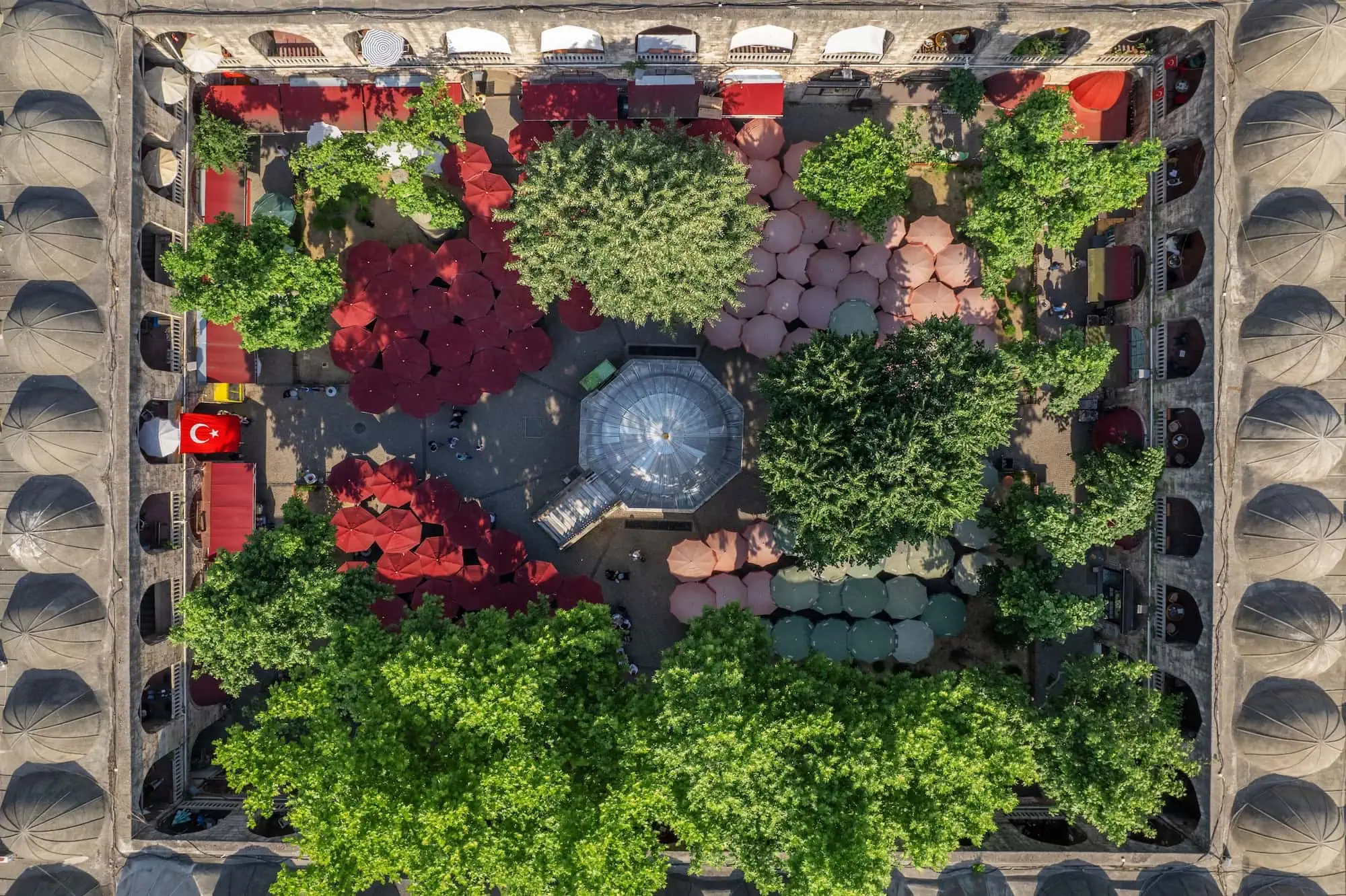 Aerial view of Koza Han Ottoman caravanserai courtyard in Bursa with market stalls and fountain