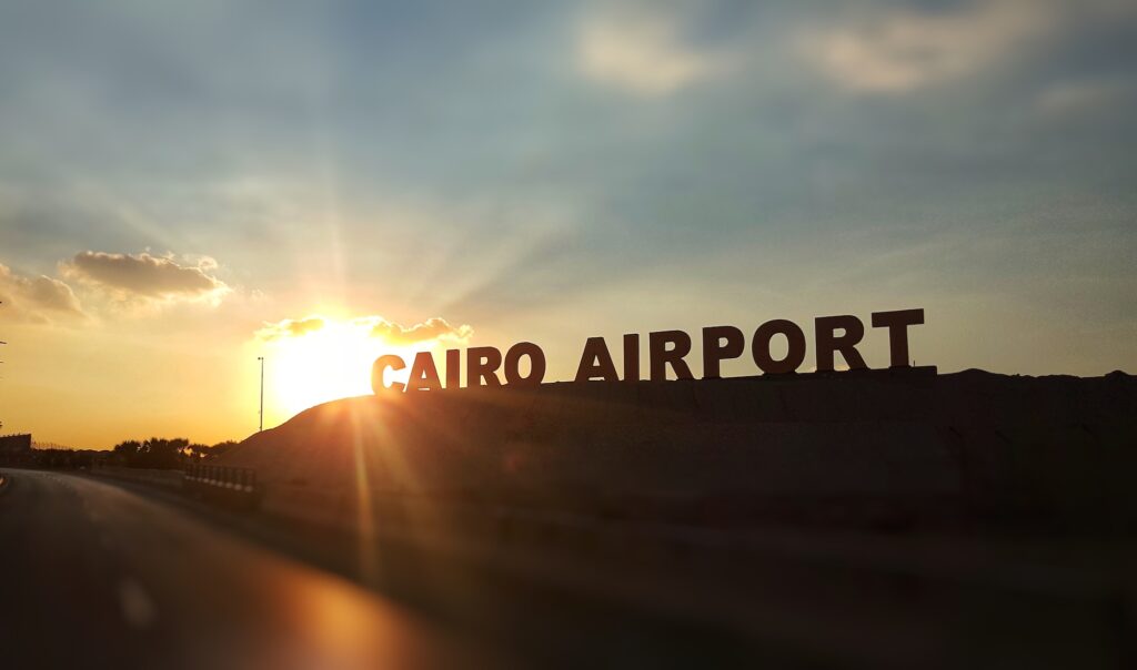 Cairo - Egypt / November 2018: sunset at the background with Cairo airport Signboard near one of the main entrances.