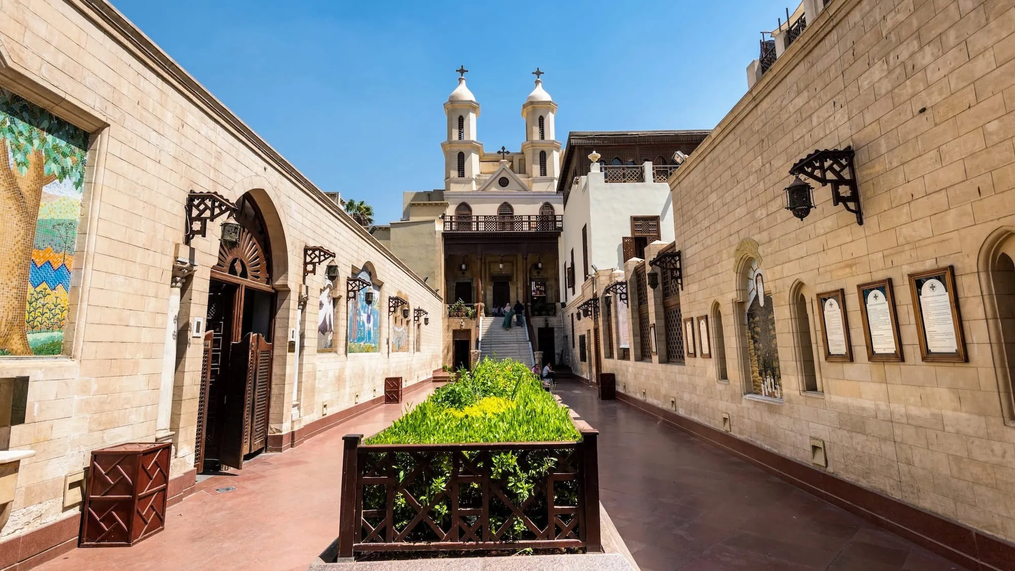 Interior courtyard of the Hanging Church in Cairo showing Coptic architecture with arched walkways and bell towers
