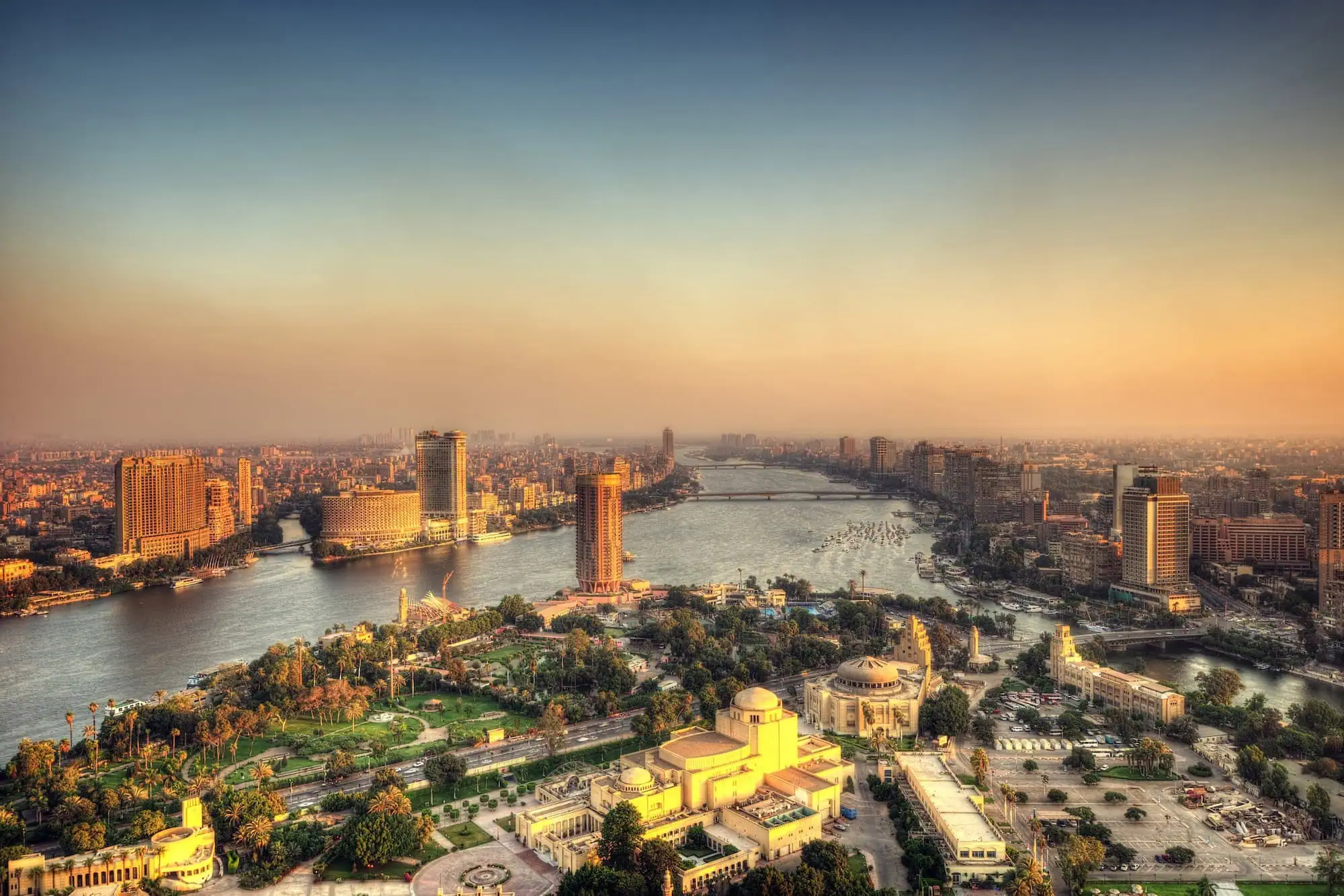 Cairo Opera House positioned along the Nile River with cityscape and gardens