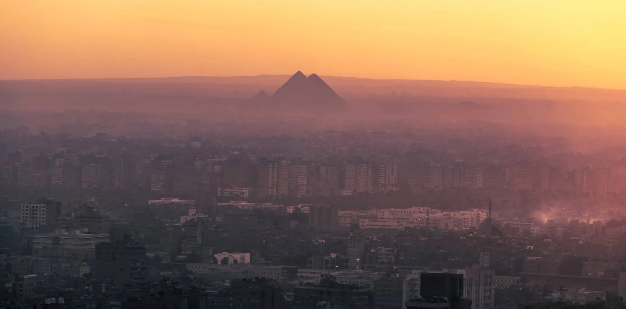 The three great pyramids of Giza rising from the desert landscape - Ancient Pyramids in Egypt