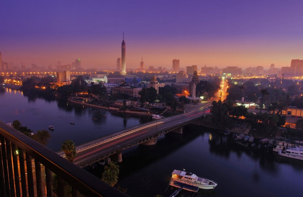 Calm Nile River reflecting Cairo’s city lights at night