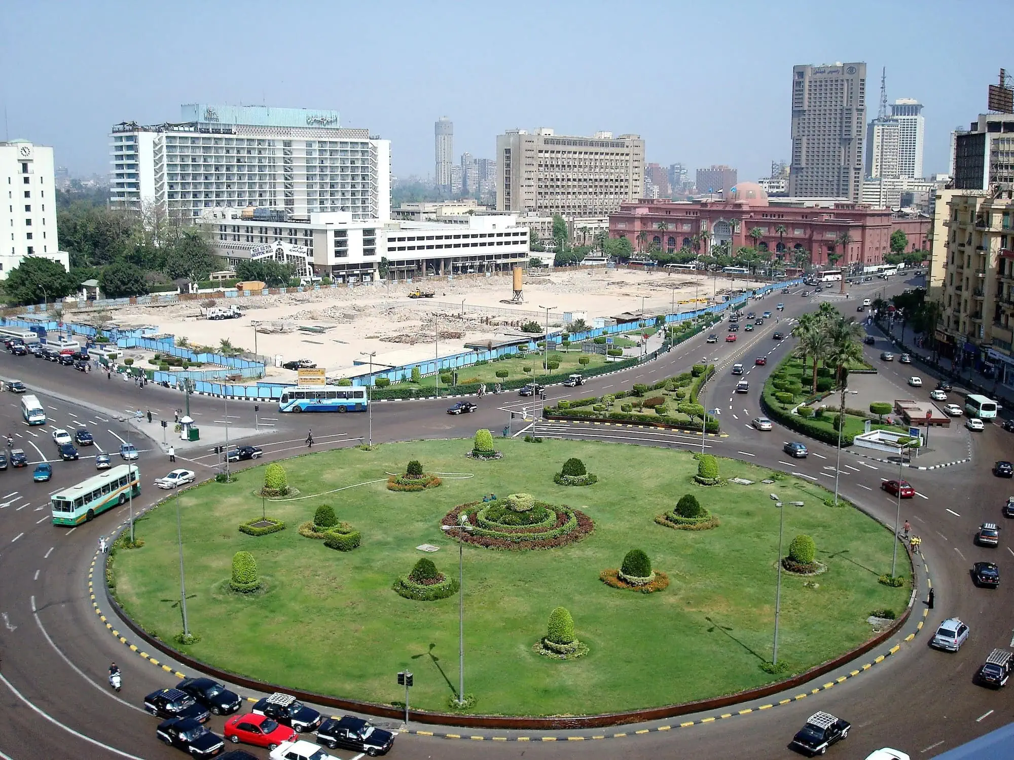 Aerial view of Tahrir Square traffic circle with cars, buses and urban transportation infrastructure in Cairo