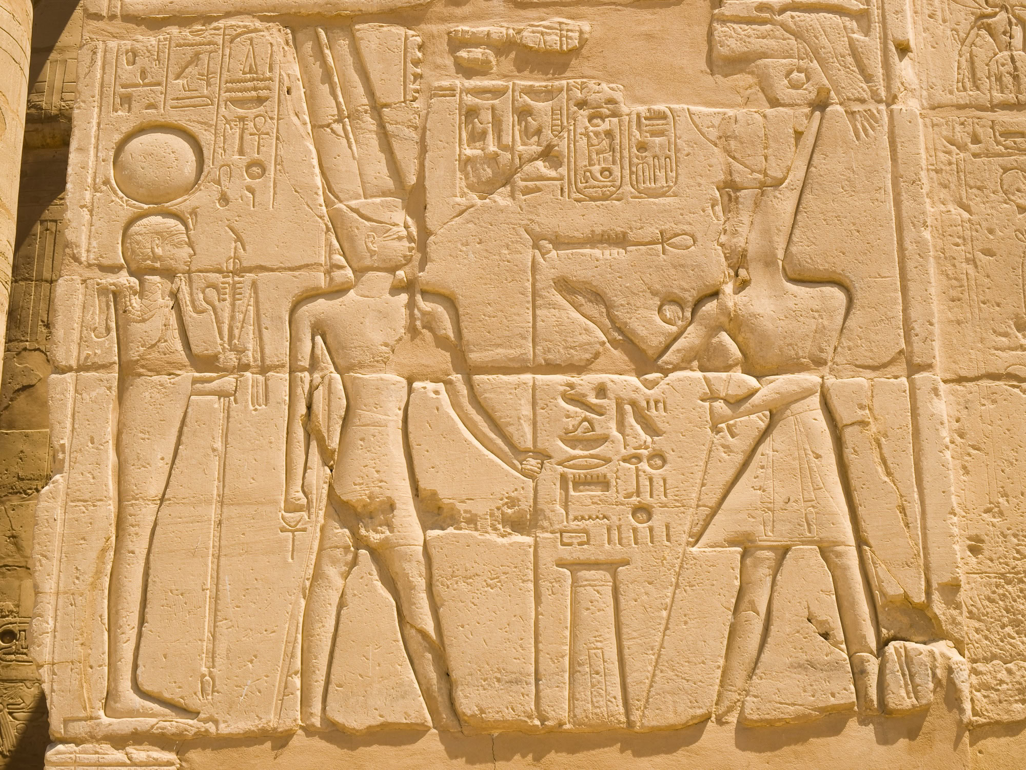 Ancient Egyptian stone relief with hieroglyphics and pharaoh figures