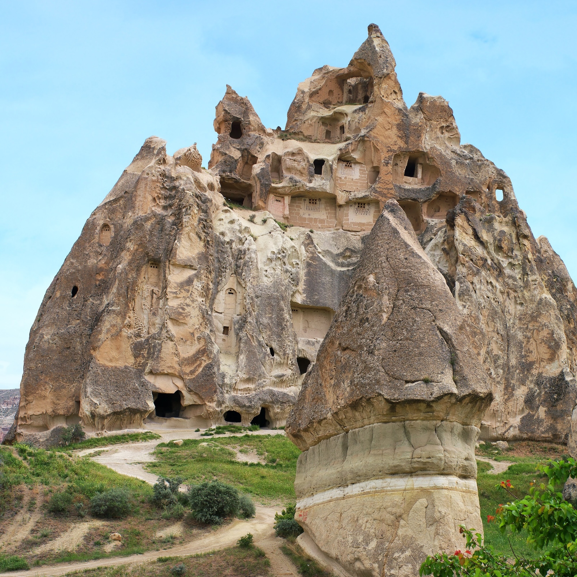 Ancient cave dwellings carved into fairy chimney rock formations in Cappadocia, Turkey