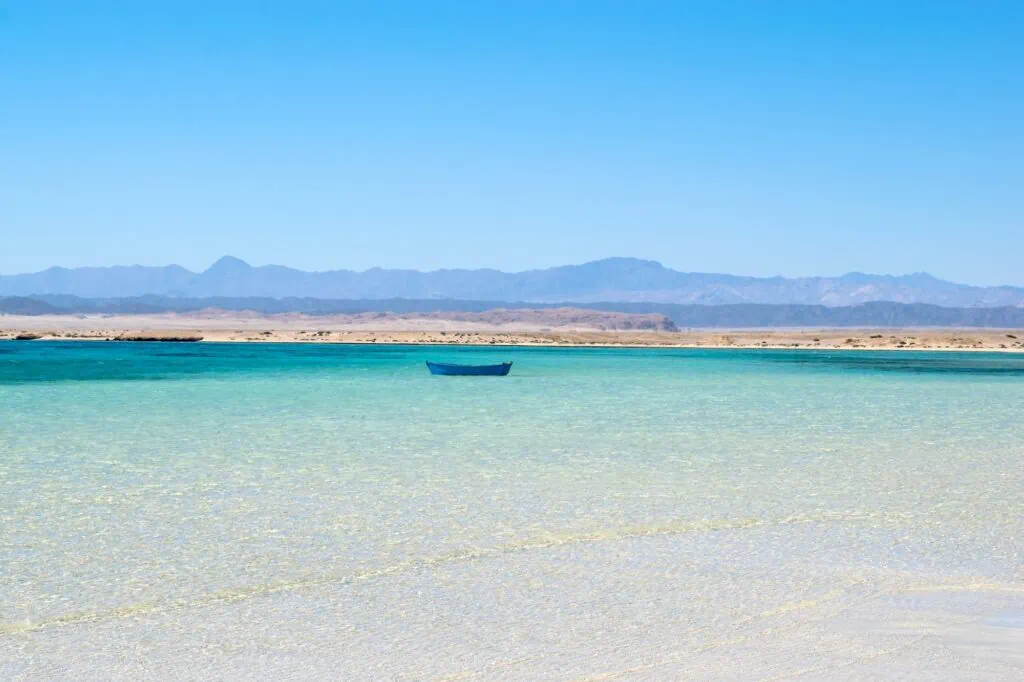 Clear turquoise waters and sandy shoreline at Hankorab Beach in Wadi El Gemal Protectorate, Marsa Alam