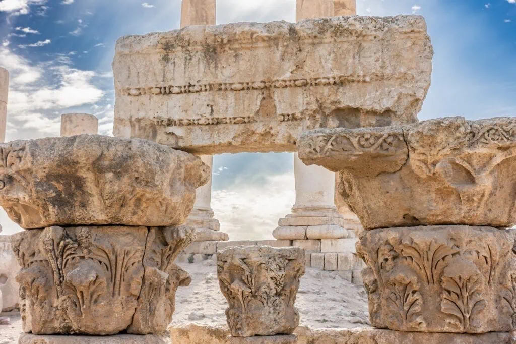 Close-up view of the unfinished Temple of Hercules with massive stone columns and carved blocks at Amman Citadel, Amman