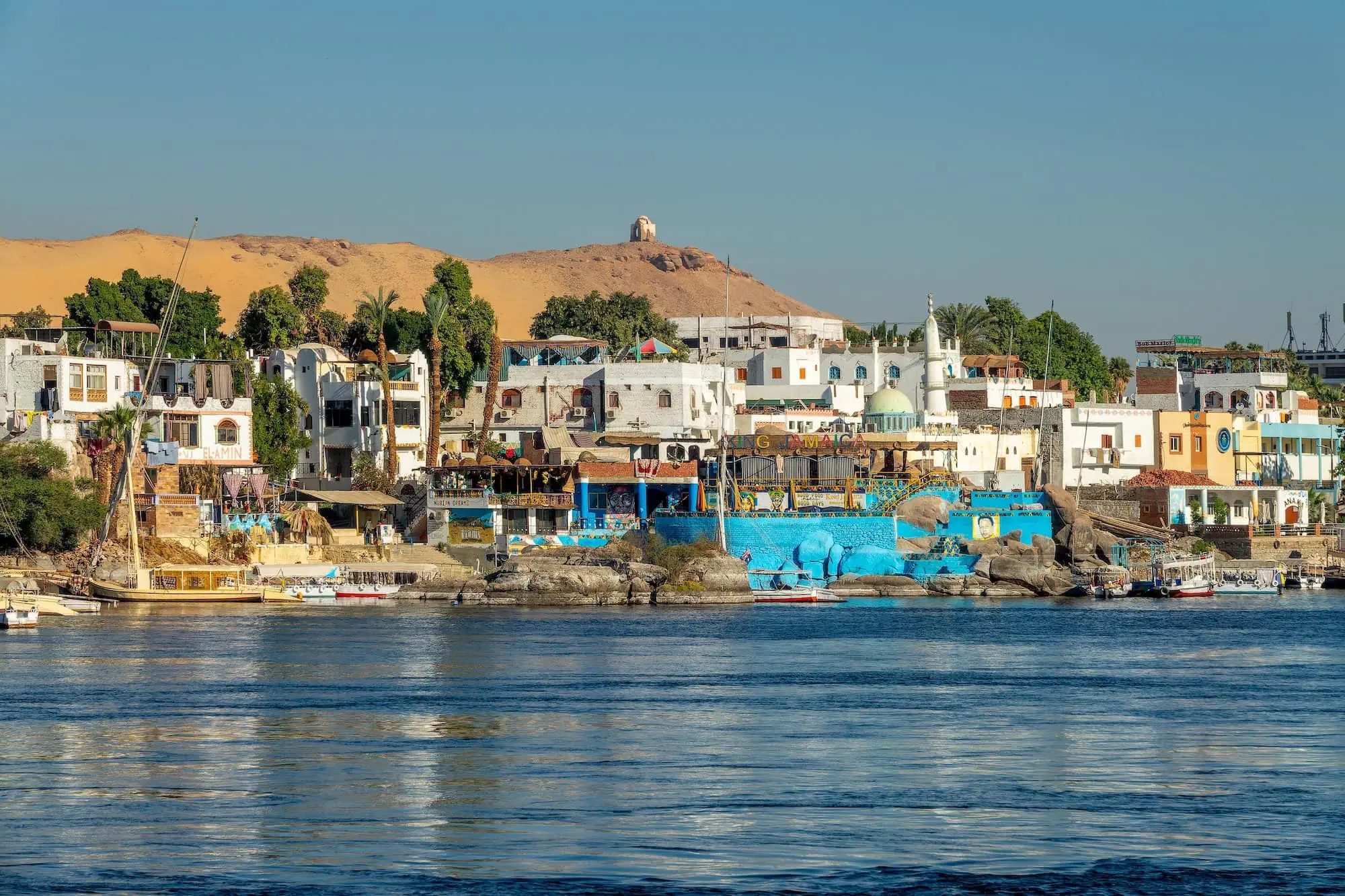 Colorful traditional Nubian houses and hotels along the Nile River on Elephantine Island