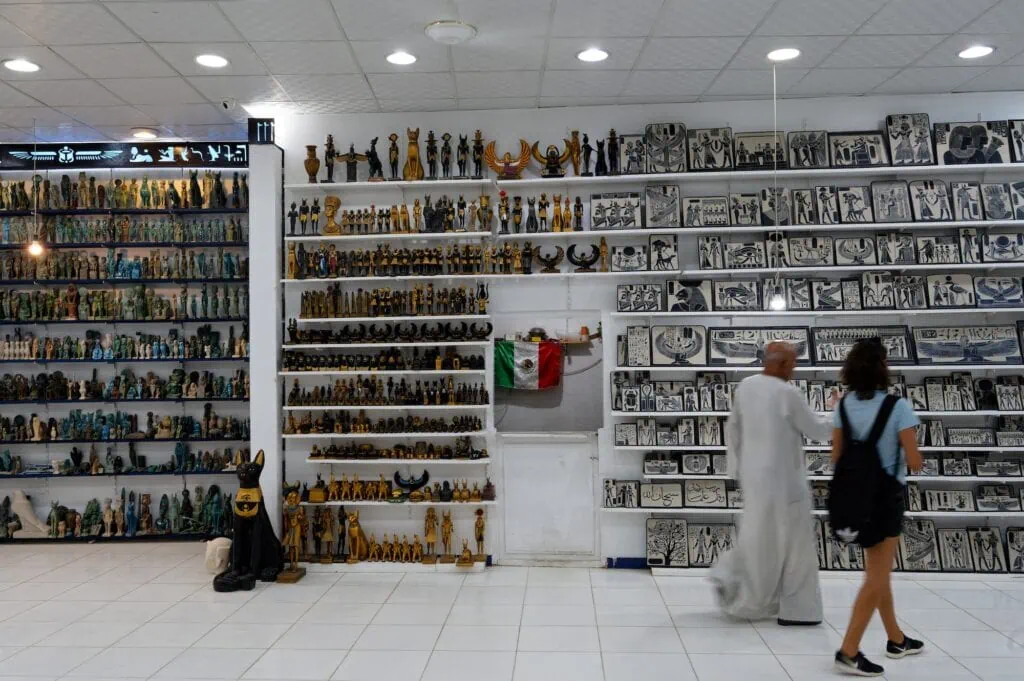 Souvenir shopping with pharaoh statues and papyrus art