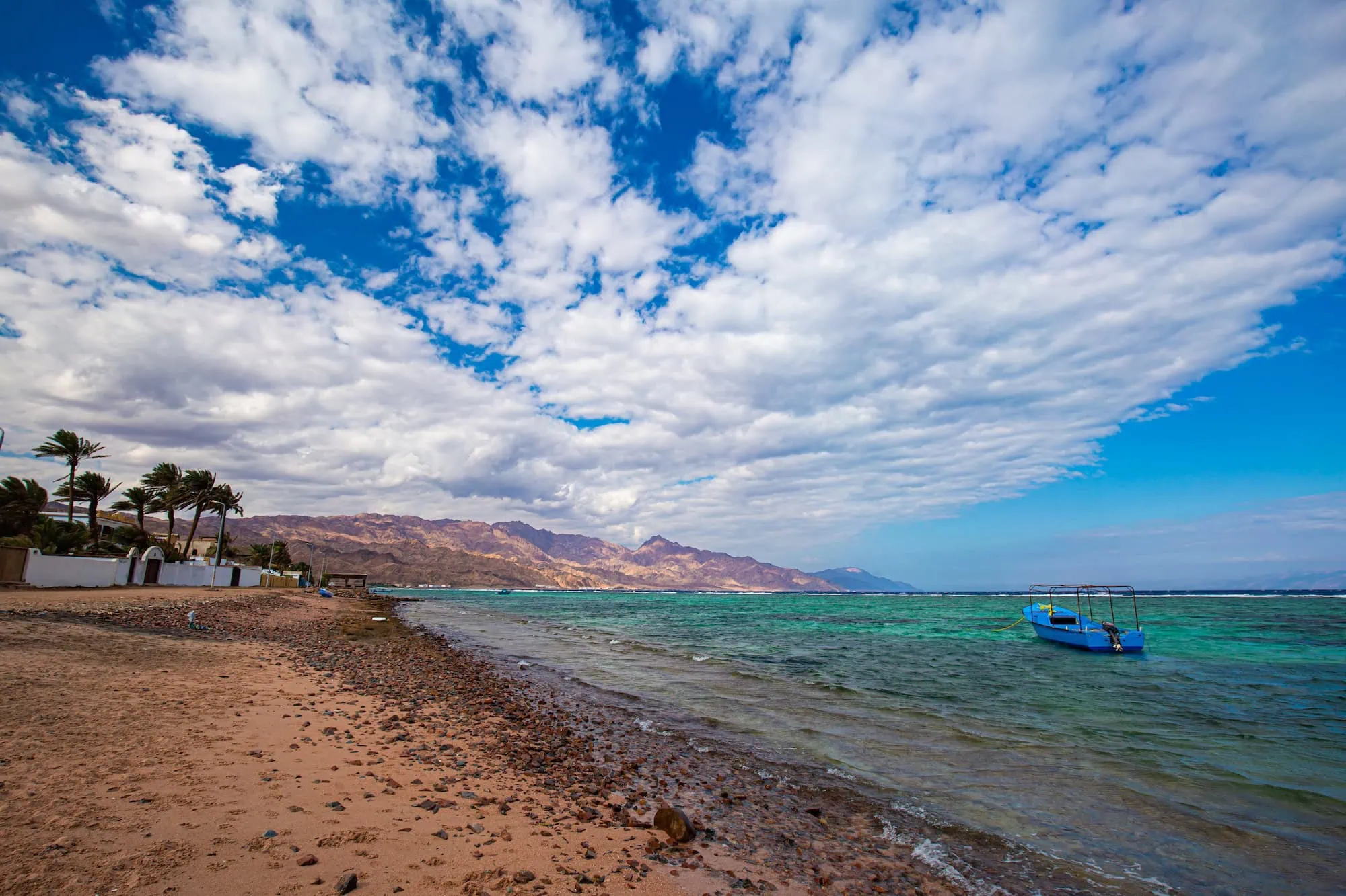 Scenic Dahab beach with turquoise Red Sea waters and desert mountains