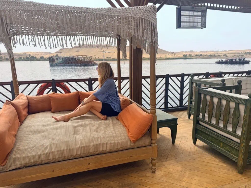 Dahabiya deck seating overlooking the Nile with passing boats, Aswan