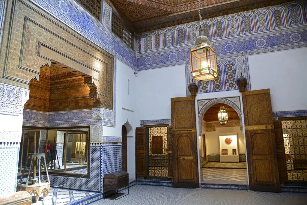 Dar Si Said Museum interior hall with carved wooden doors, zellij tilework, and decorative painted ceiling Marrakech