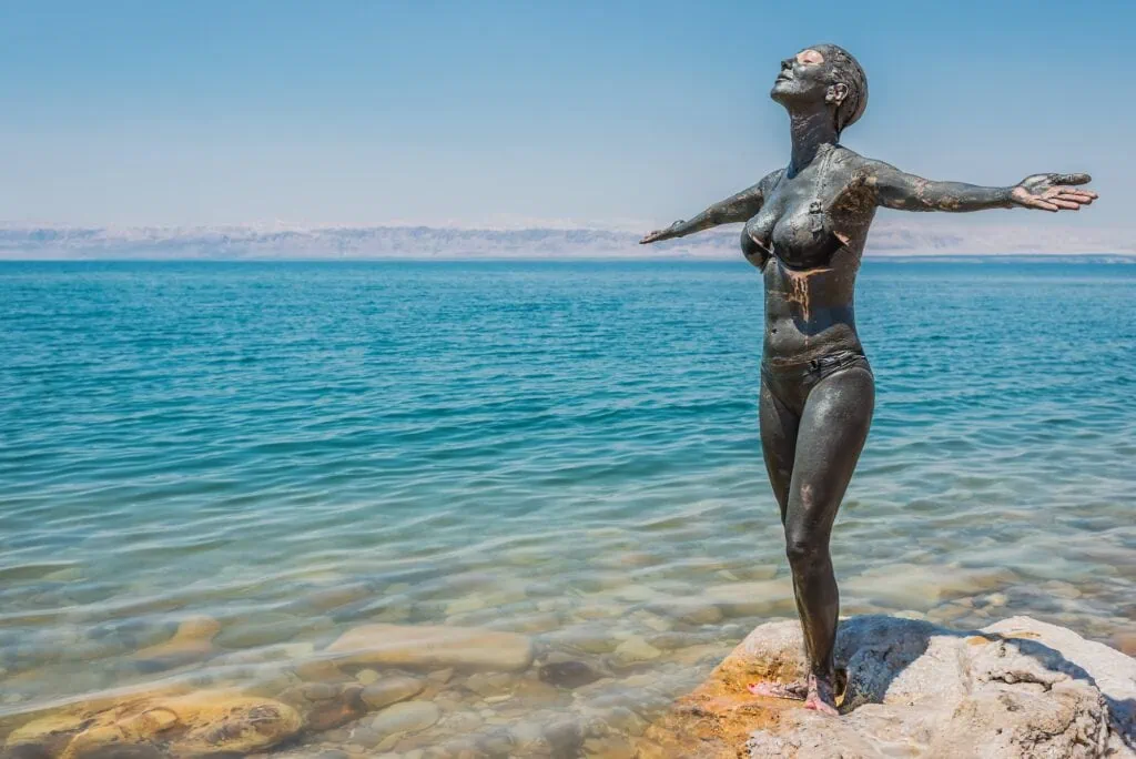 Woman applying Dead Sea mud treatment