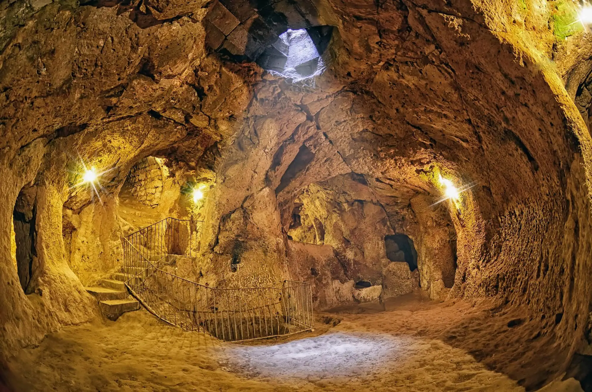 Interior view of Derinkuyu underground city with carved stone chambers and arched openings