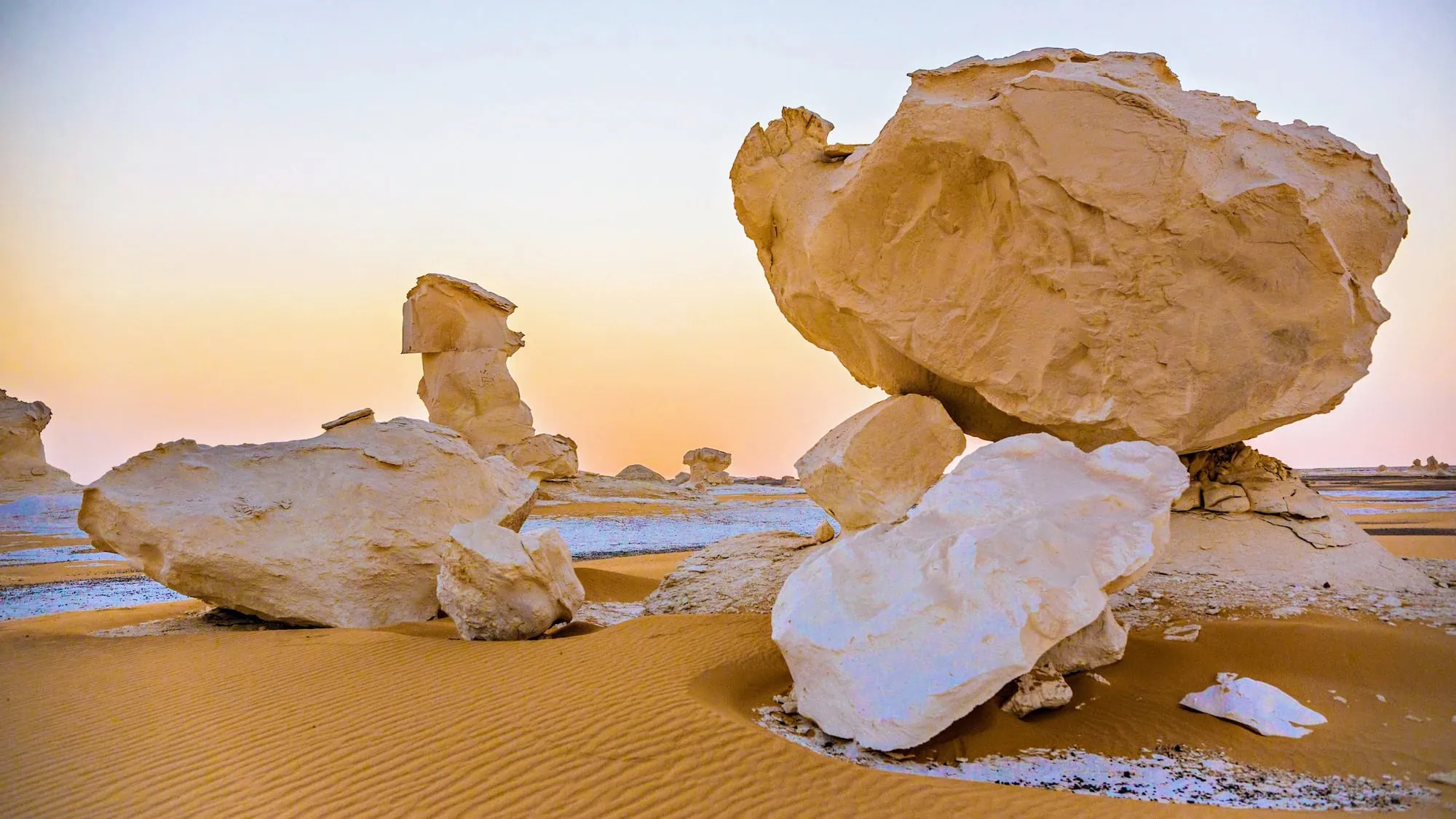 Surreal white limestone formations and wind-carved balancing rocks in Egypt's White Desert
