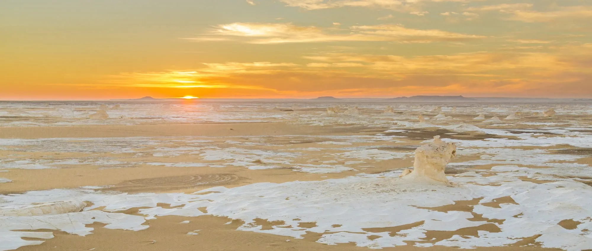 White Desert limestone rock formations at sunset with dramatic sky
