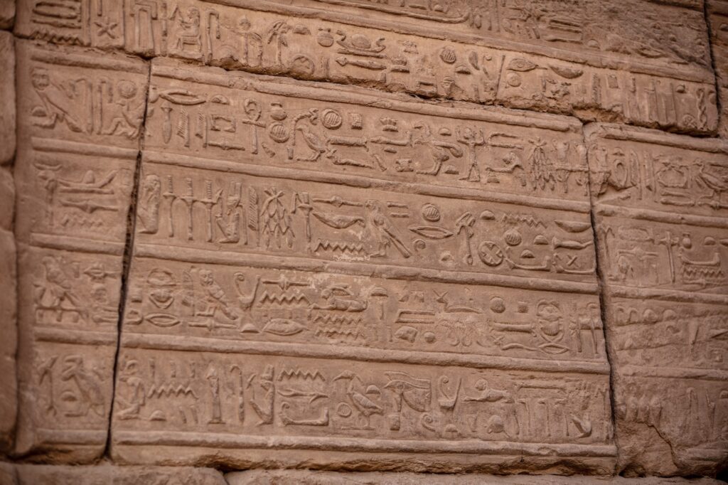Ancient hieroglyphs carved into the walls of Karnak Temple