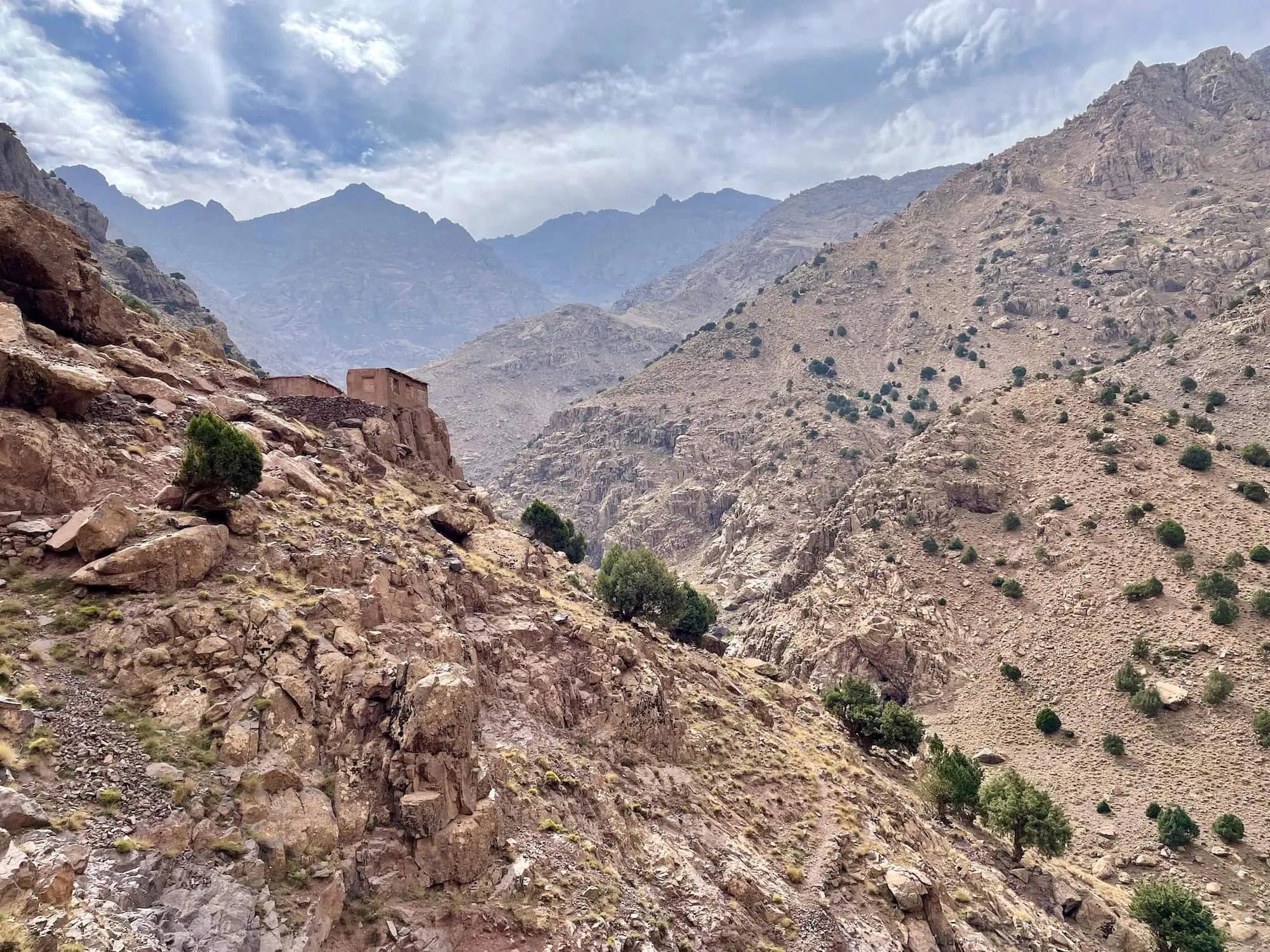 Desert mountain landscape in High Atlas Morocco showing rocky valley and traditional building