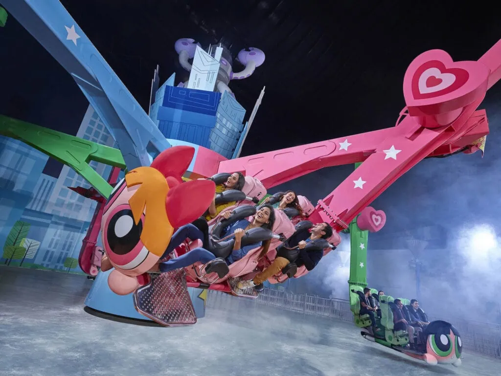 Colorful spinning ride with suspended seats inside IMG Worlds of Adventure Dubai